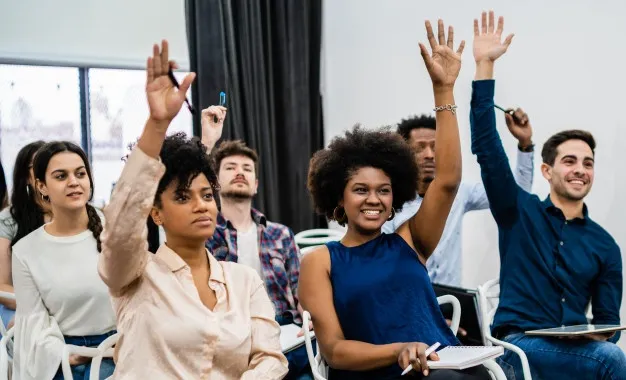 Team Synergy - a group of people raising their hands