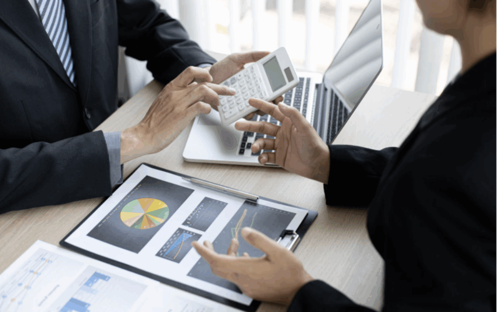 Human Capital Risk - two business people sitting at a table with a laptop and papers