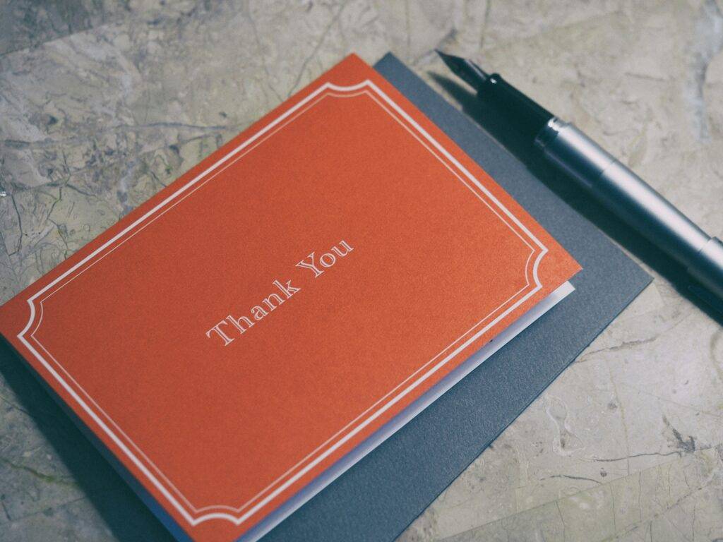 Workplace Appreciation: A red card with the words “Thank you” written.